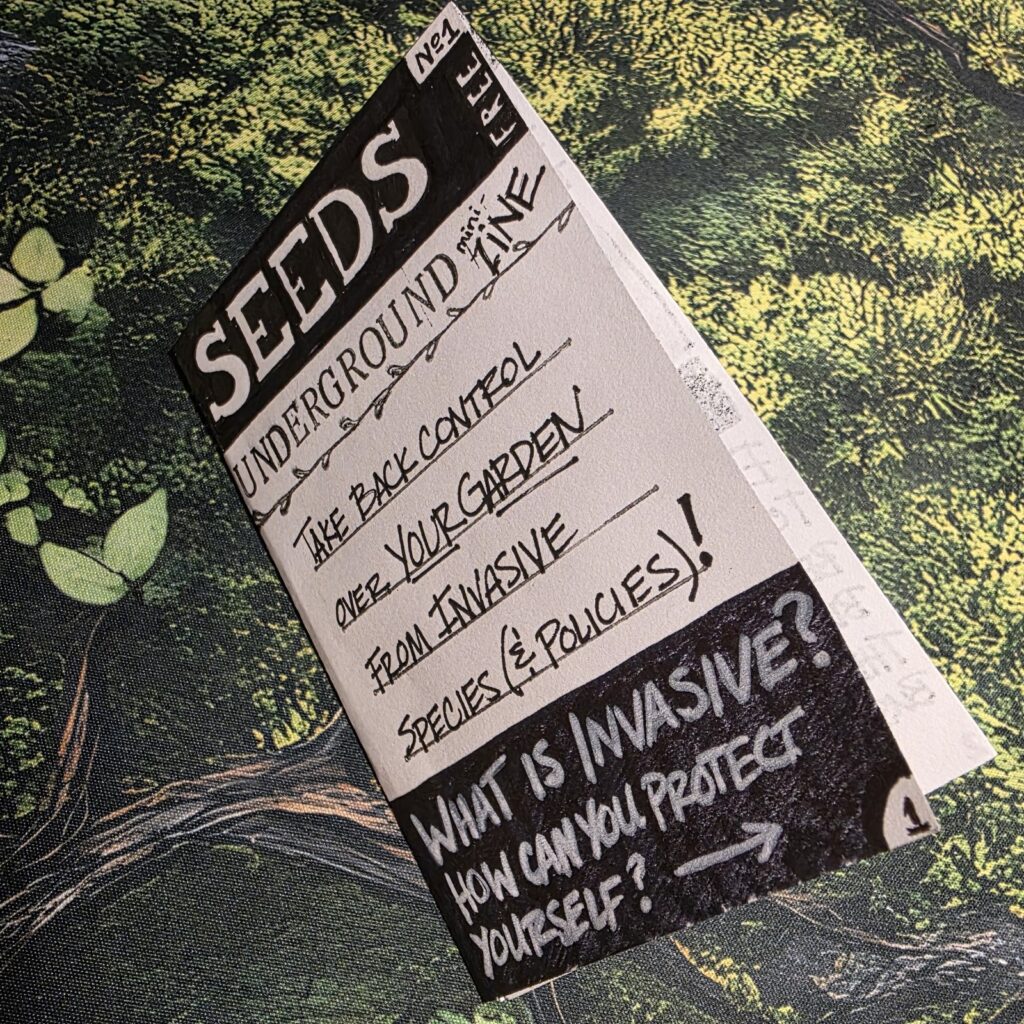 Seeds Underground Zine number 1 shown folded with the cover facing up on top of a printed mossy desk pad.